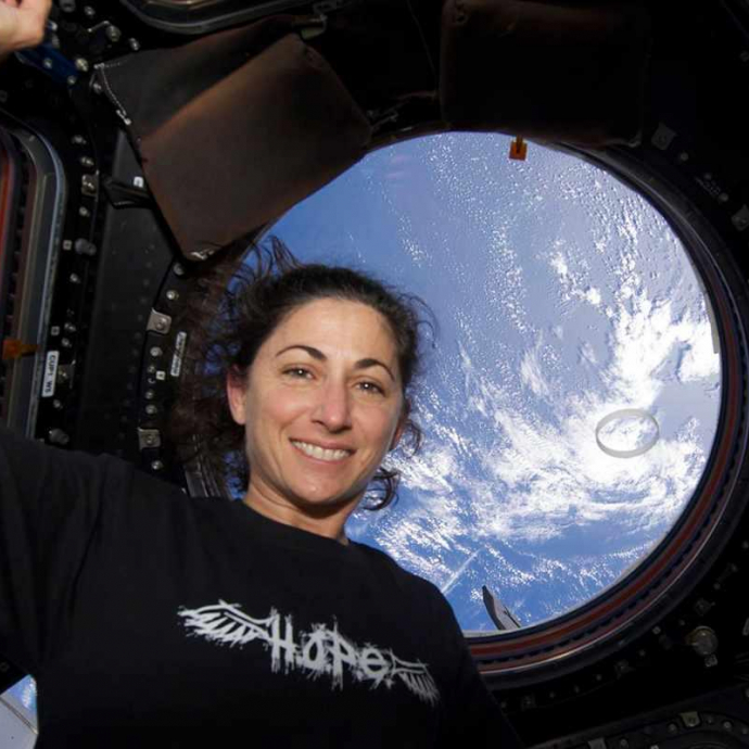 Nicole Stott at International Space Station looking out the window with a view of Earth